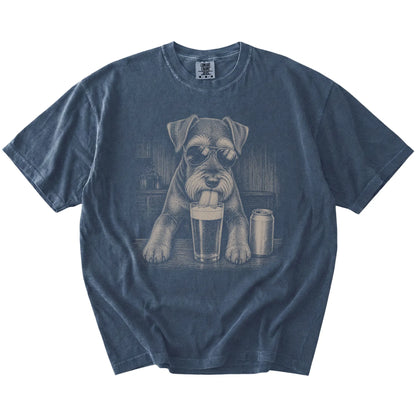 Schnauzer sneaking a drink from a foamy pint at home on a Denim Comfort Colors® t-shirt
