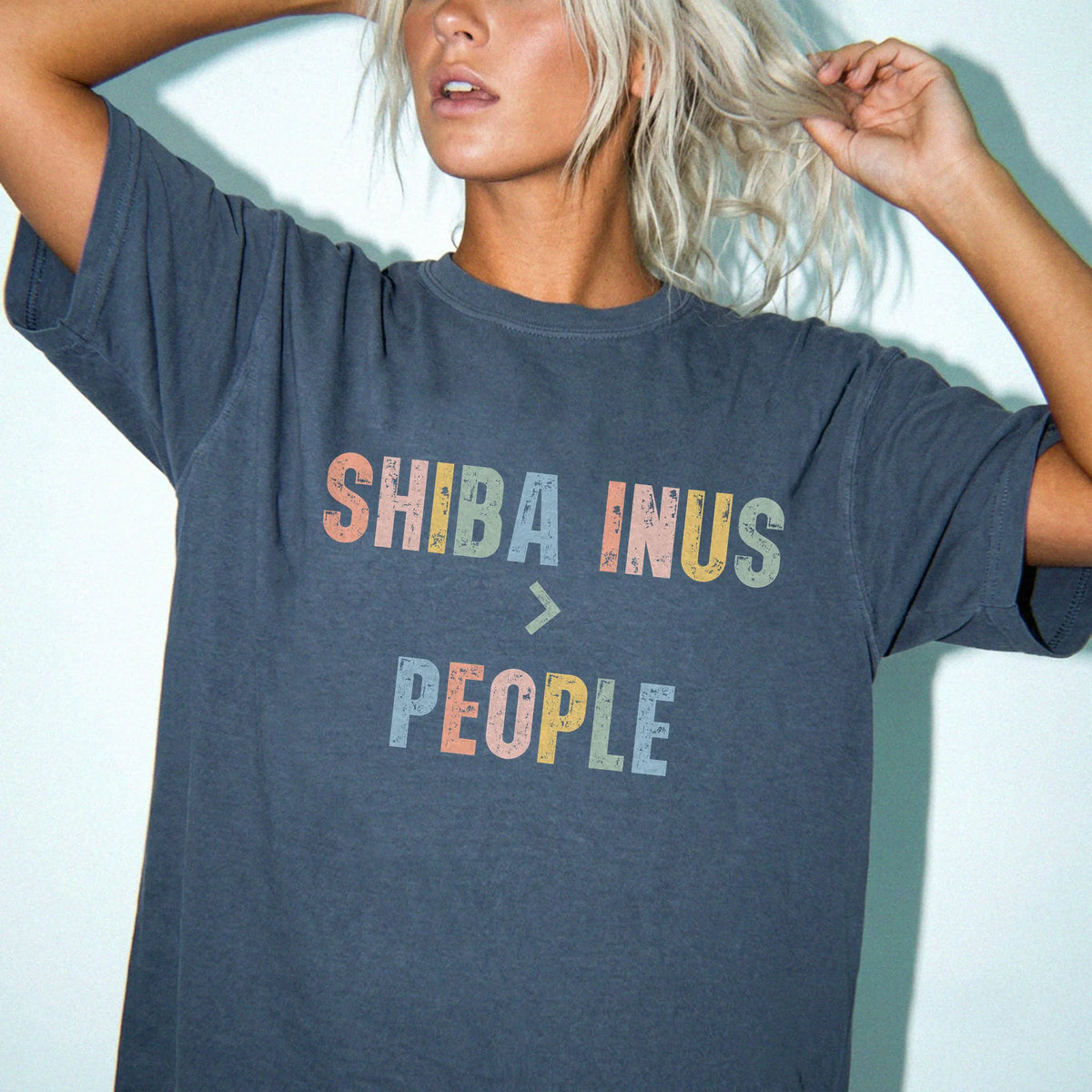 Model wearing a Denim Comfort Colors® T-shirt with “Shiba Inus > People” text