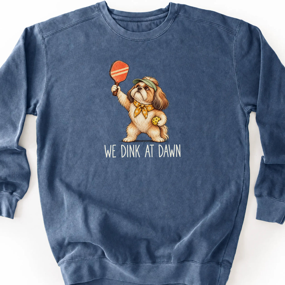 Shih Tzu with a pickleball paddle and ball on a Denim Comfort Colors® sweatshirt with We Dink at Dawn text