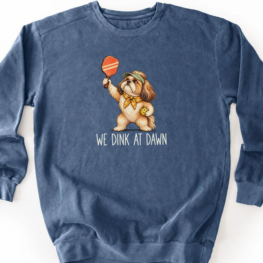 Shih Tzu with a pickleball paddle and ball on a Denim Comfort Colors® sweatshirt with We Dink at Dawn text