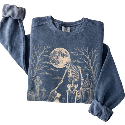 Folded Denim sweatshirt with a skeleton petting a Bernese Mountain Dog in a graveyard
