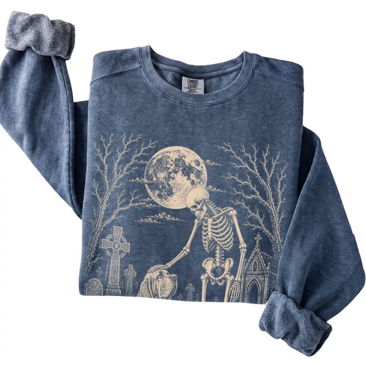 Folded Denim sweatshirt with a skeleton petting a Bloodhound in a graveyard