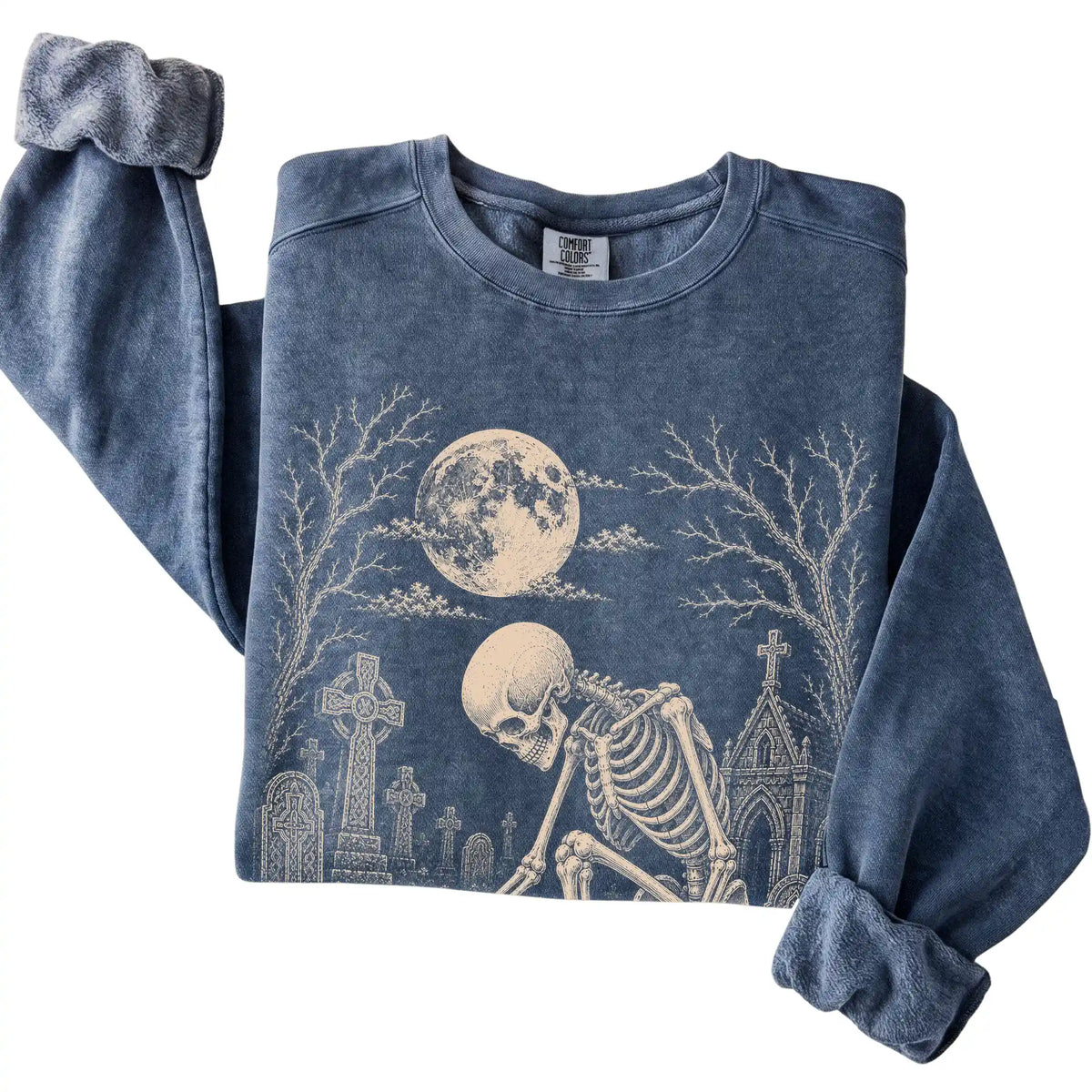 Folded Denim sweatshirt with a skeleton petting a Chihuahua in a graveyard