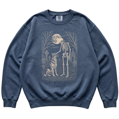Skeleton petting a German Shepherd in a graveyard on a Denim sweatshirt