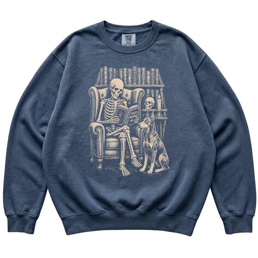Skeleton reading Tales Beyond to a Doberman on a Denim sweatshirt
