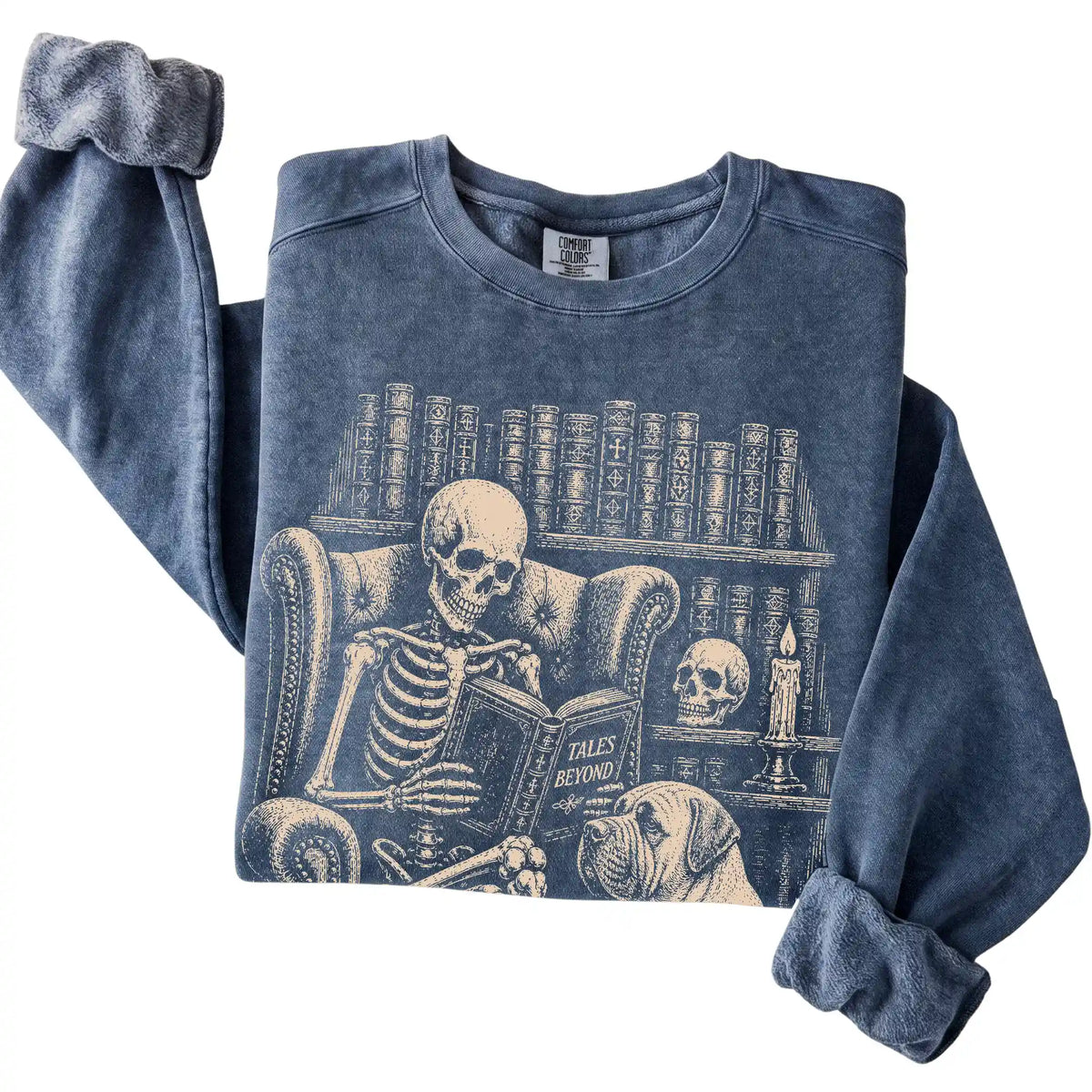 Folded Denim sweatshirt with a skeleton reading Tales Beyond to a Mastiff