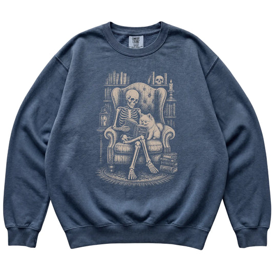 Skeleton reading Tales Beyond to a Pomeranian on a Denim sweatshirt