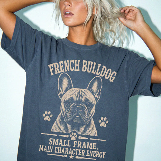 Model wearing a Denim Comfort Colors® T-shirt featuring French Bulldog design with “Small Frame, Main Character Energy” lette