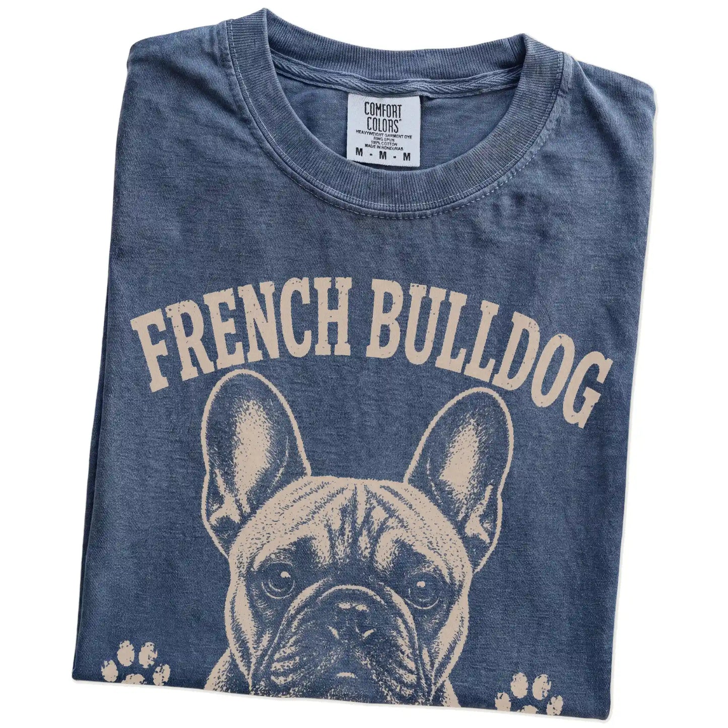 Folded Denim Comfort Colors® T-shirt showing French Bulldog design with “Small Frame, Main Character Energy” lettering