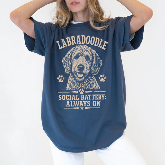 Model wearing a Denim Comfort Colors® T-shirt featuring Labradoodle design with “Social Battery” lettering