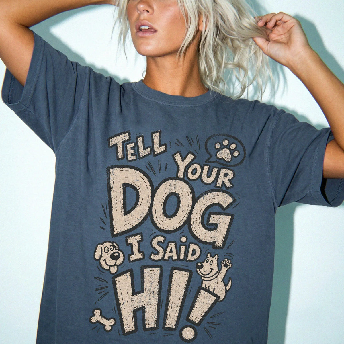 Model wearing a Denim Comfort Colors® T-shirt with tell your dog i said hi lettering