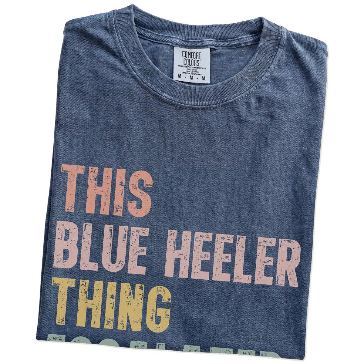 Folded Denim Comfort Colors® T-shirt showing retro “This Blue Heeler Thing Escalated Quickly” lettering