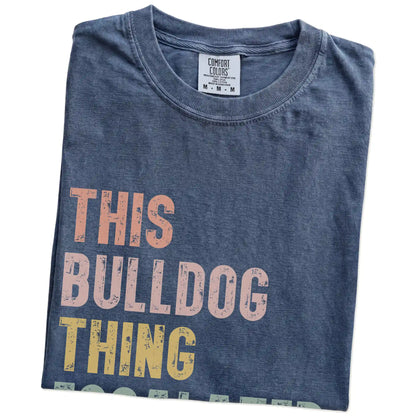Folded Denim Comfort Colors® T-shirt showing retro “This Bulldog Thing Escalated Quickly” lettering