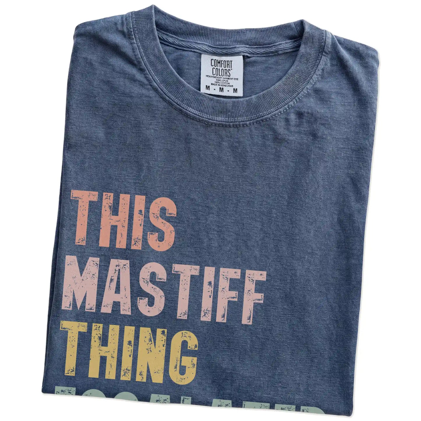 Folded Denim Comfort Colors® T-shirt showing retro “This Mastiff Thing Escalated Quickly” lettering