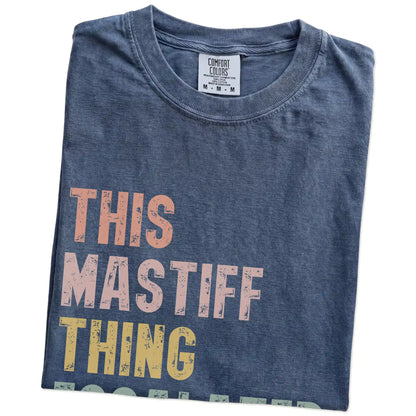 Folded Denim Comfort Colors® T-shirt showing retro “This Mastiff Thing Escalated Quickly” lettering