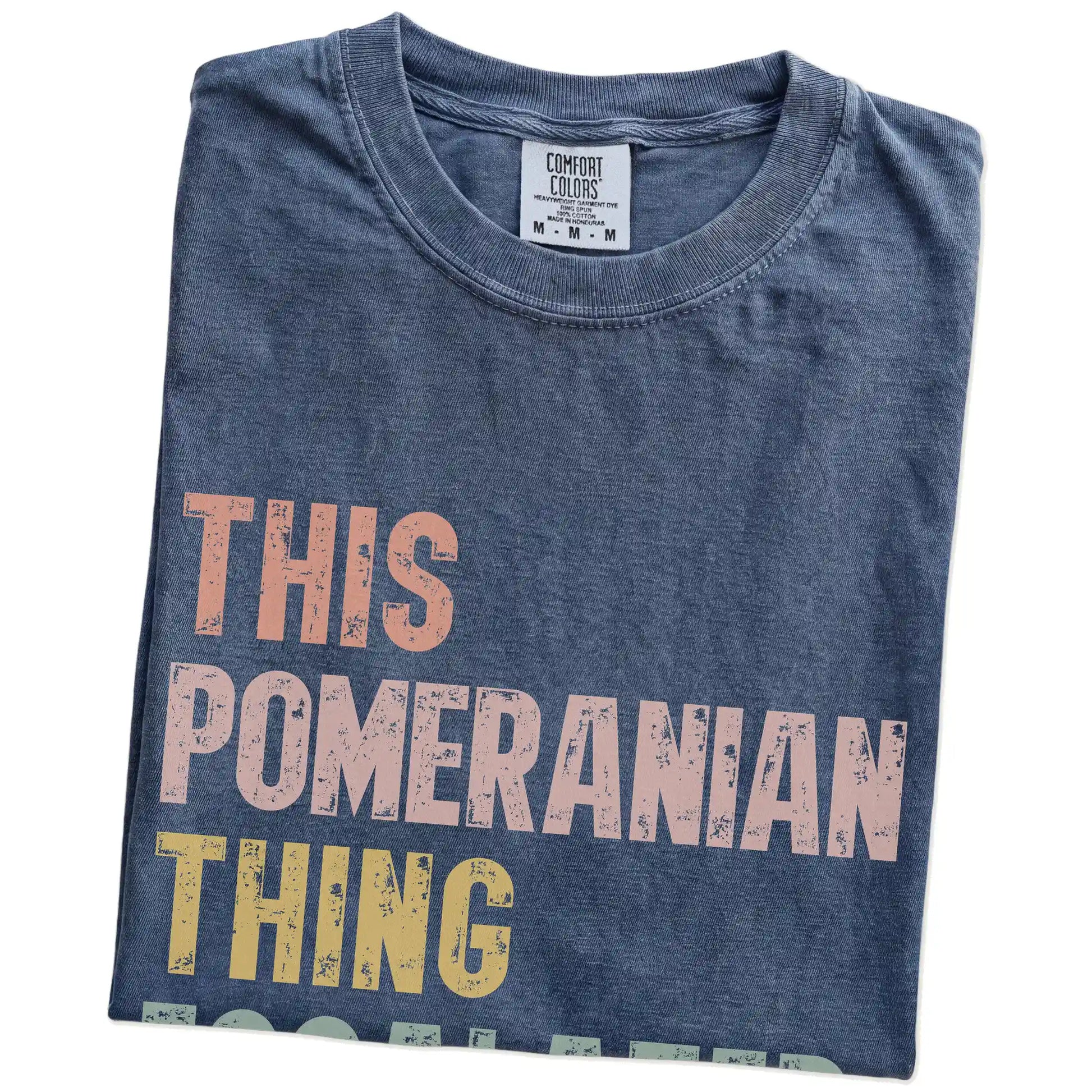 Folded Denim Comfort Colors® T-shirt showing retro “This Pomeranian Thing Escalated Quickly” lettering