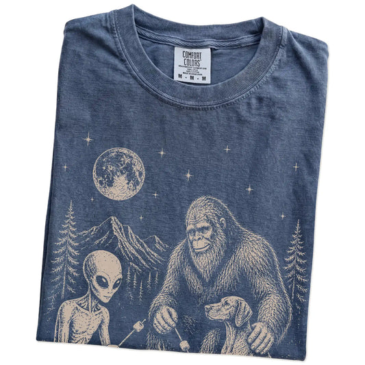 Folded Denim Comfort Colors® T-shirt showing Vizsla camping with Bigfoot and an alien