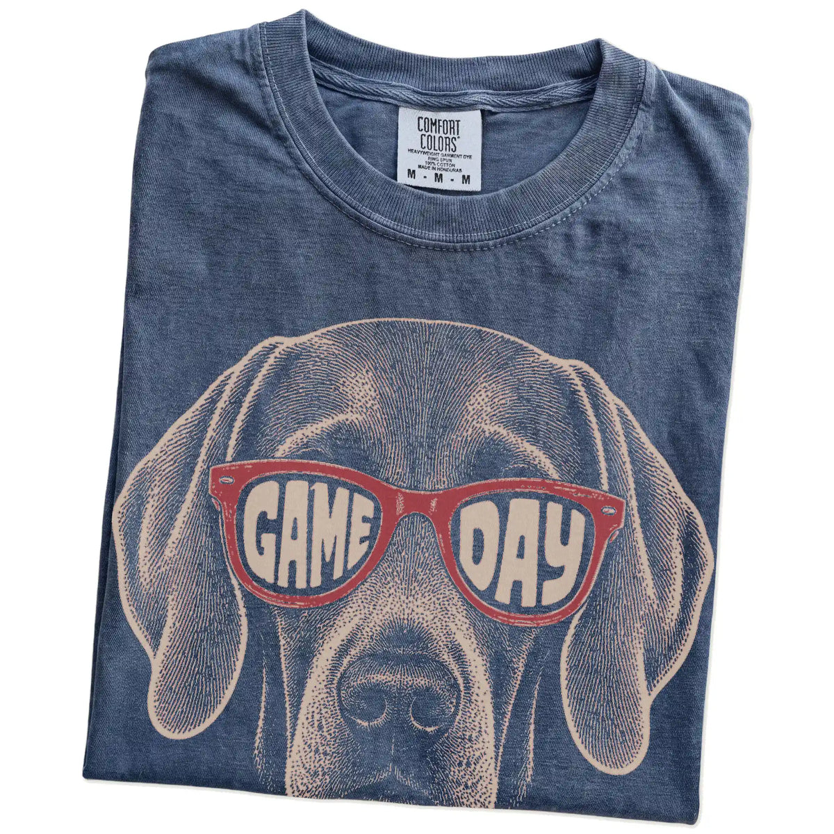 Folded Denim Comfort Colors® T-shirt showing weimaraner wearing red game day sunglasses