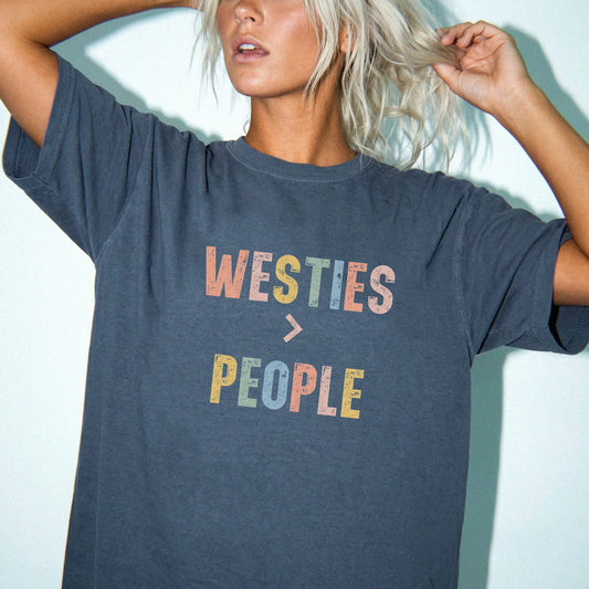 Model wearing a Denim Comfort Colors® T-shirt with “Westies > People” text