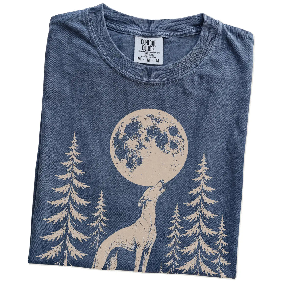 Folded Denim Comfort Colors® T-shirt showing a Whippet howling beneath the moon and pine trees