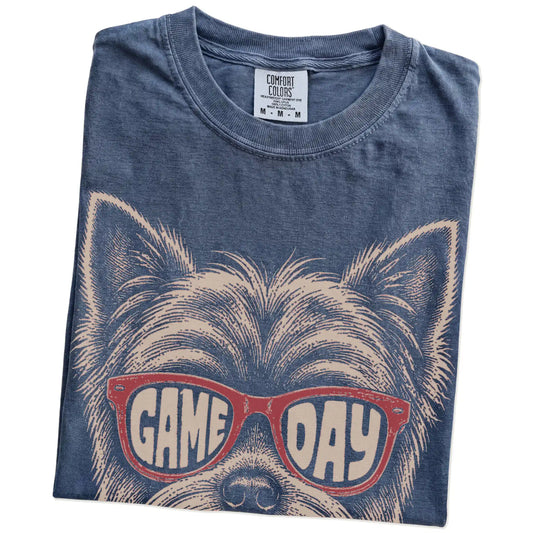 Folded Denim Comfort Colors® T-shirt showing yorkie wearing red game day sunglasses