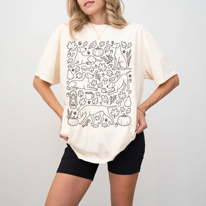 Model wearing a Ivory Comfort Colors® T-shirt with Pointer dogs with pumpkins, leaves, acorns, and woodland details