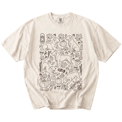 Rottweiler dogs with pumpkins, leaves, acorns, and woodland details on a Ivory Comfort Colors® T-shirt