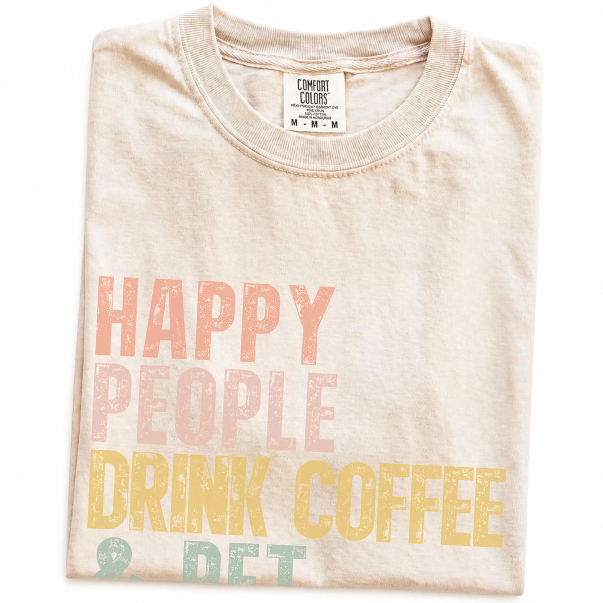 Folded Ivory Comfort Colors® T-shirt showing Chihuahua with coffee and “Happy People Drink Coffee and Pet Dogs” lettering