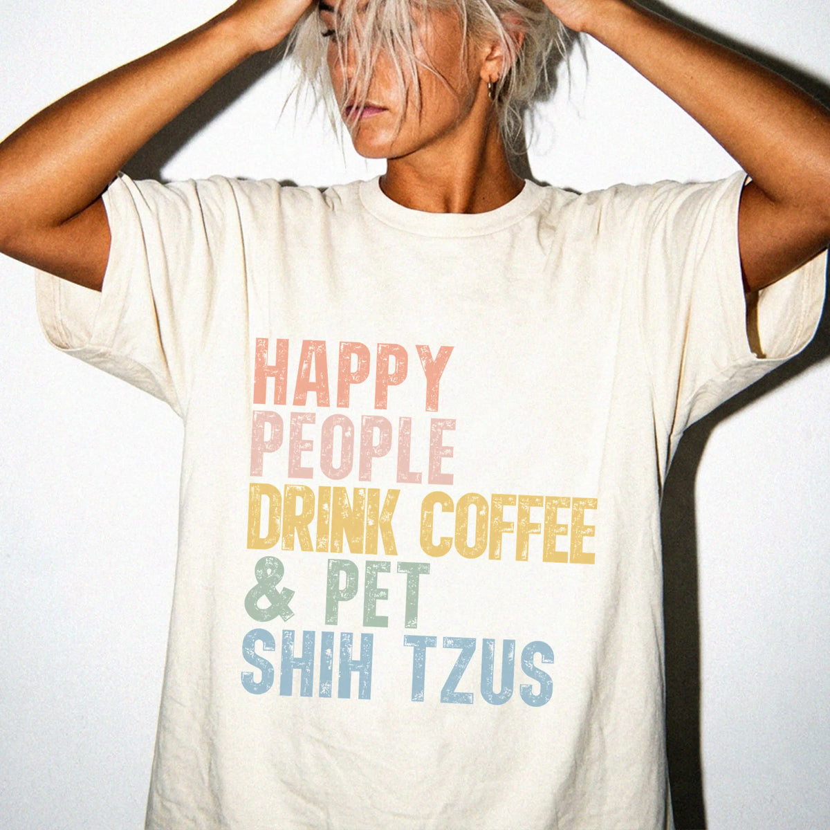 Model wearing a Ivory Comfort Colors® T-shirt featuring Shih Tzu with coffee and “Happy People Drink Coffee and Pet Dogs” let