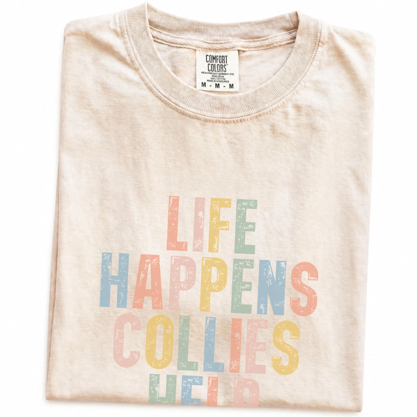 Folded Ivory Comfort Colors® T-shirt showing Collie making hard days better with “Life Happens, Dogs Help” lettering