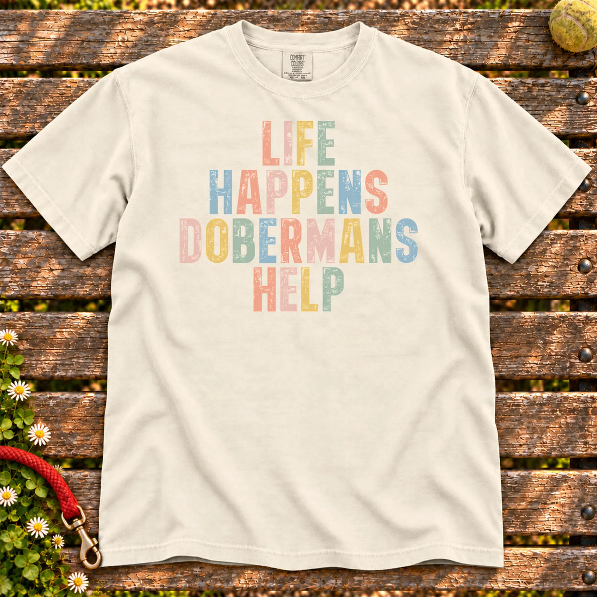 Doberman making hard days better with “Life Happens, Dogs Help” lettering on a Ivory Comfort Colors® T-shirt