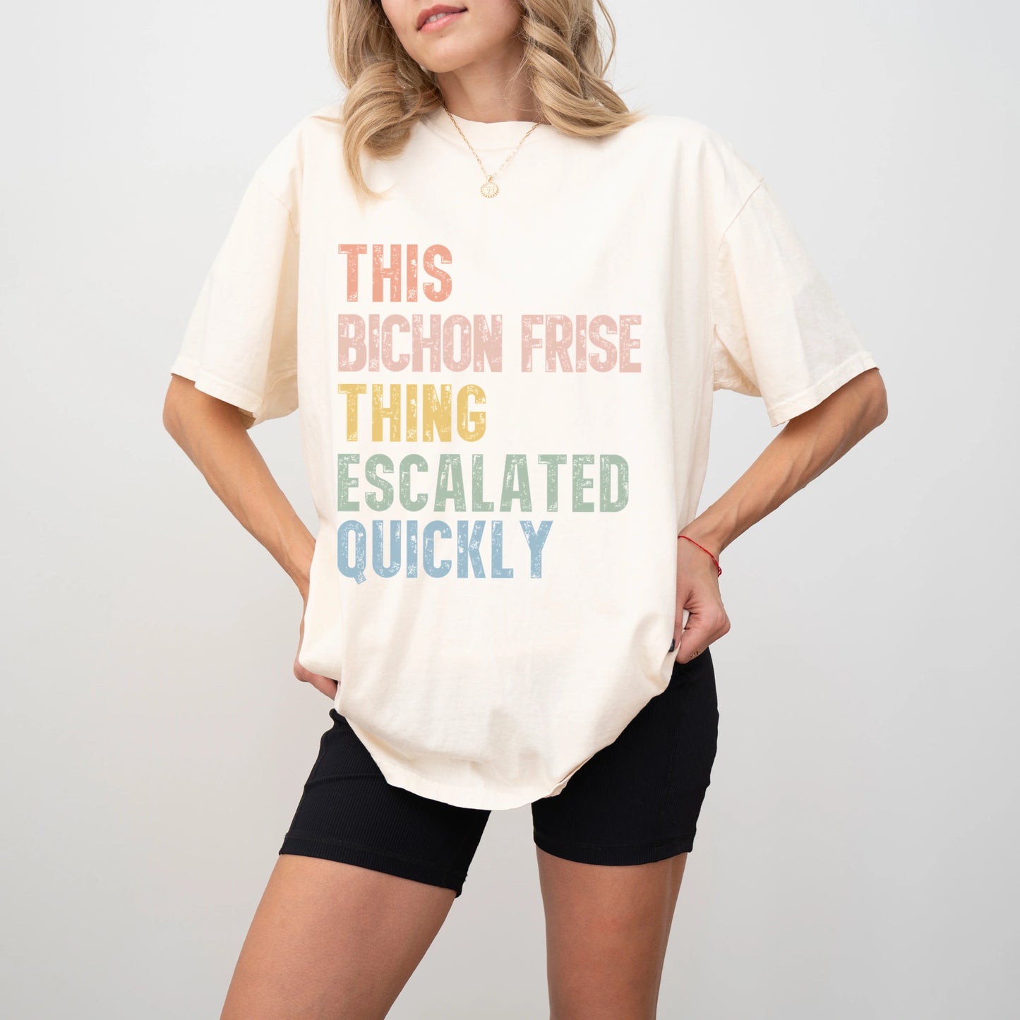 Model wearing a Ivory Comfort Colors® T-shirt with retro “This Bichon Frise Thing Escalated Quickly” lettering