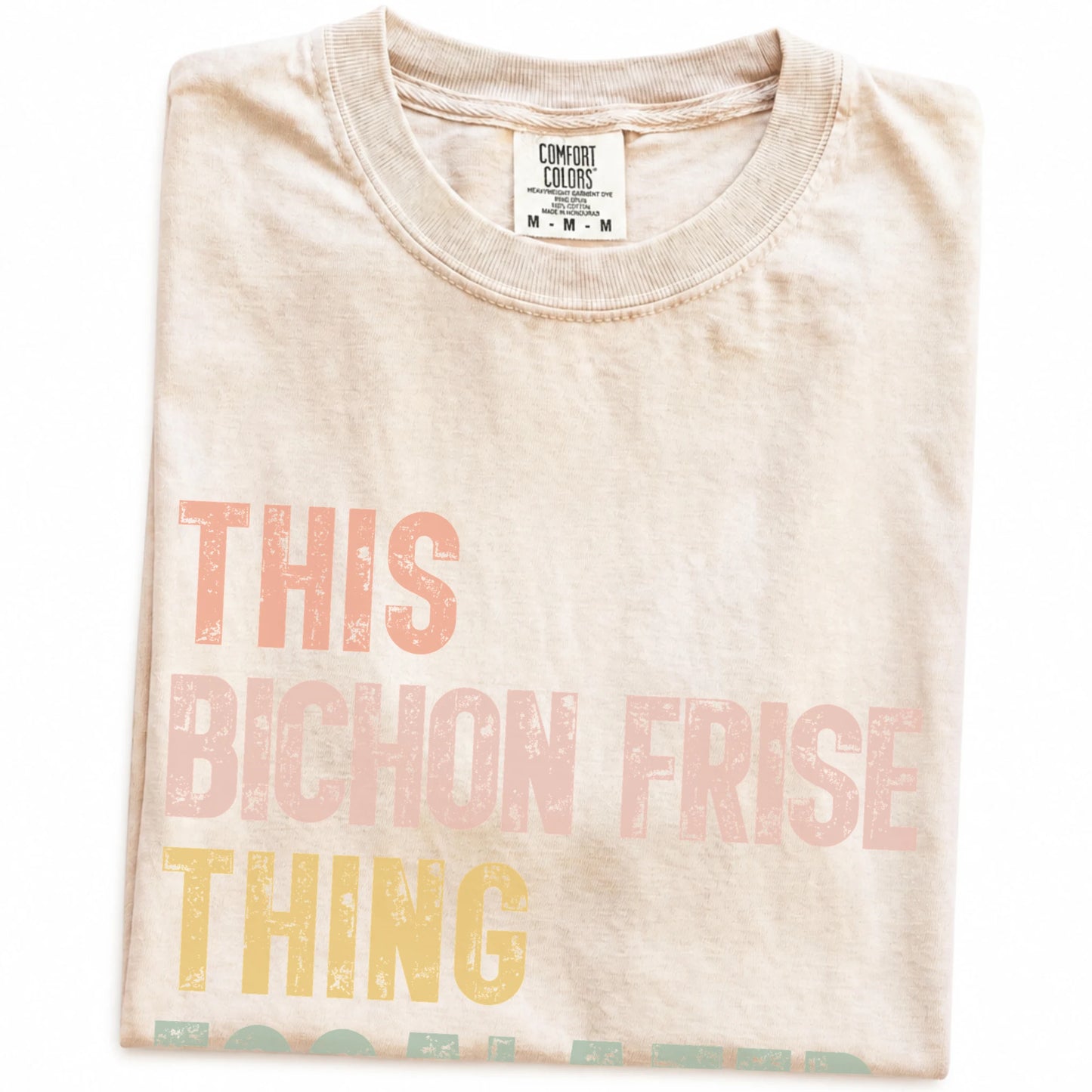 Folded Ivory Comfort Colors® T-shirt showing retro “This Bichon Frise Thing Escalated Quickly” lettering