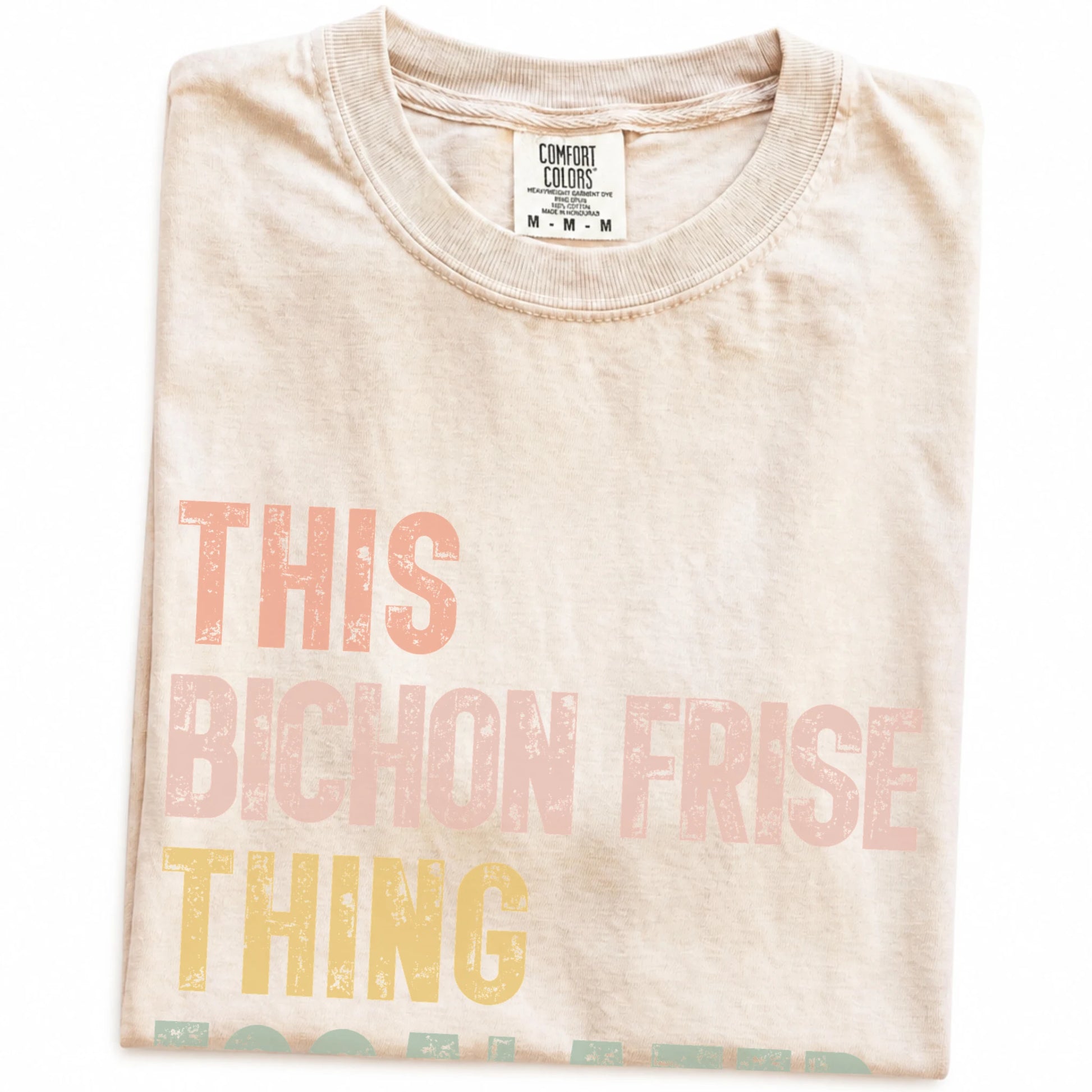 Folded Ivory Comfort Colors® T-shirt showing retro “This Bichon Frise Thing Escalated Quickly” lettering