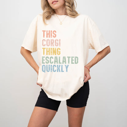Model wearing a Ivory Comfort Colors® T-shirt with retro “This Corgi Thing Escalated Quickly” lettering
