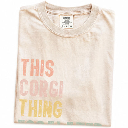 Folded Ivory Comfort Colors® T-shirt showing retro “This Corgi Thing Escalated Quickly” lettering