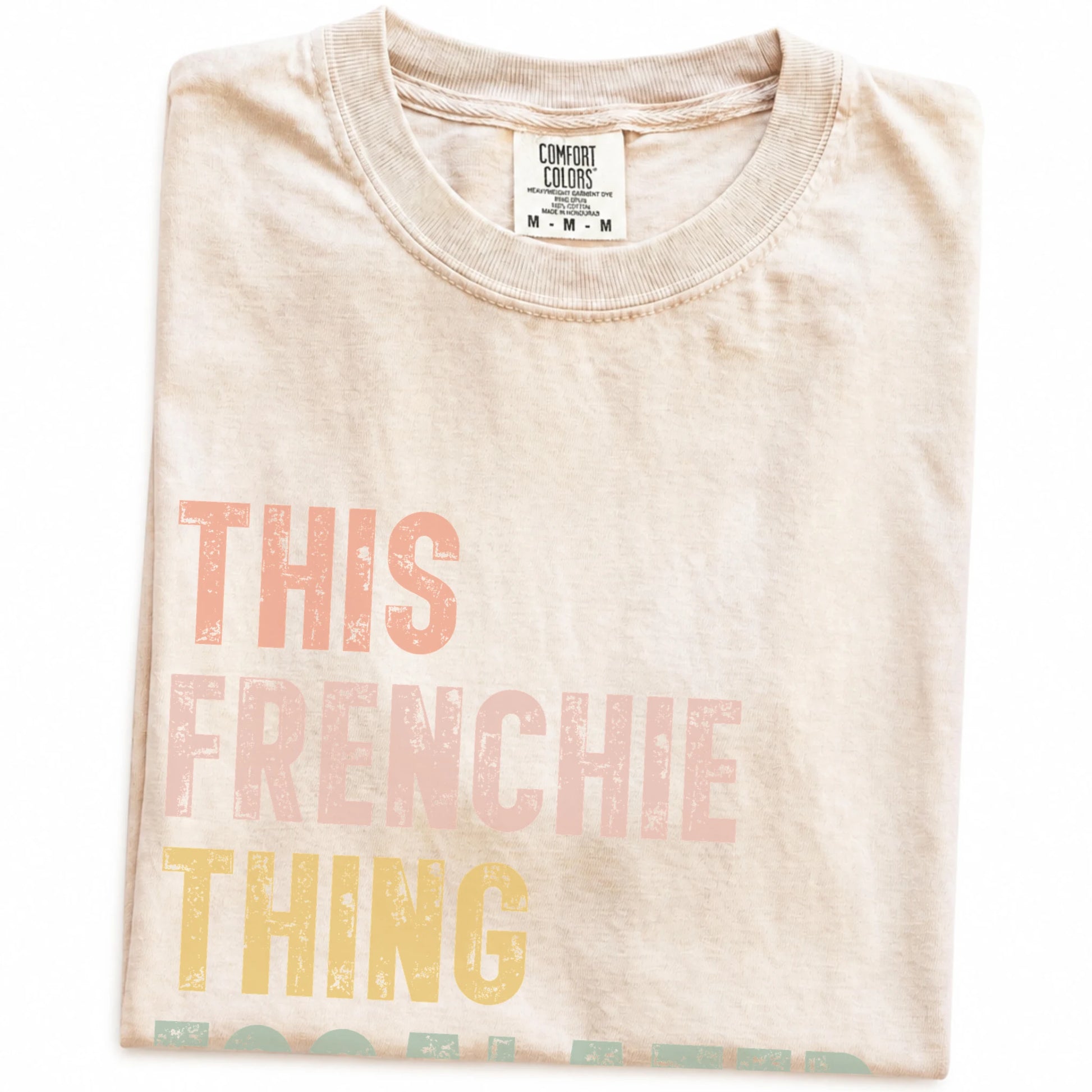 Folded Ivory Comfort Colors® T-shirt showing retro “This French Bulldog Thing Escalated Quickly” lettering