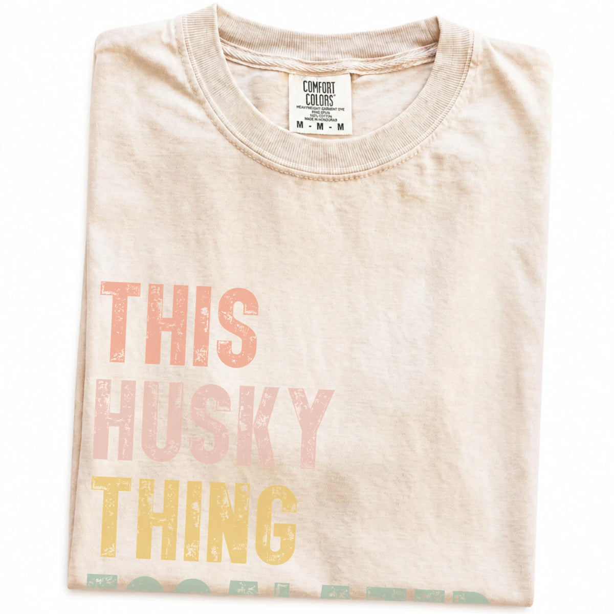 Folded Ivory Comfort Colors® T-shirt showing retro “This Husky Thing Escalated Quickly” lettering