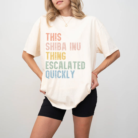 Model wearing a Ivory Comfort Colors® T-shirt with retro “This Shiba Inu Thing Escalated Quickly” lettering