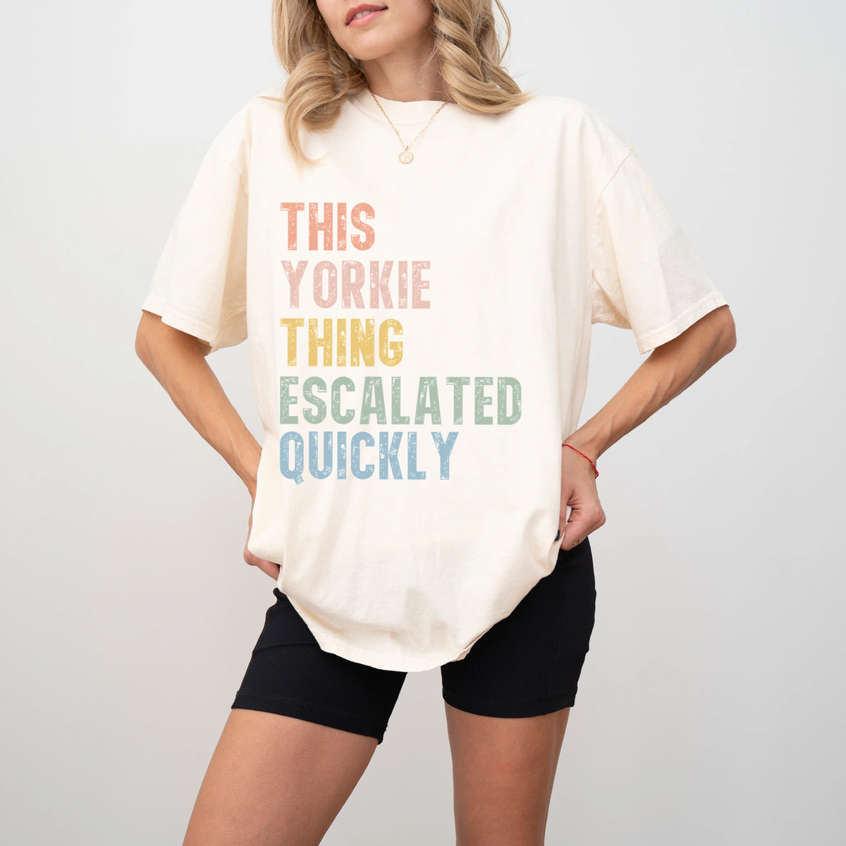 Model wearing a Ivory Comfort Colors® T-shirt with retro “This Yorkie Thing Escalated Quickly” lettering