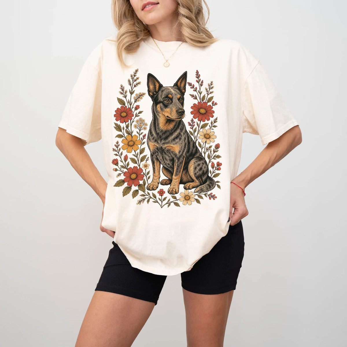 Model wearing an Ivory Comfort Colors® T-shirt showing Blue Heeler portrait surrounded by wildflowers beneath the moon