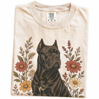 Folded Ivory Comfort Colors® T-shirt showing Cane Corso portrait surrounded by wildflowers beneath the moon