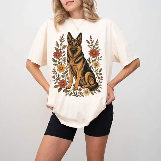 Model wearing an Ivory Comfort Colors® T-shirt showing German Shepherd portrait surrounded by wildflowers beneath the moon