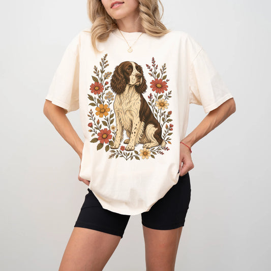 Model wearing an Ivory Comfort Colors® T-shirt showing Springer Spaniel portrait surrounded by wildflowers beneath the moon