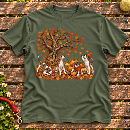 Four Greyhound puppies with pumpkins beneath an autumn tree on a Military Green softstyle T-shirt