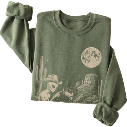 Military Green crewneck sweatshirt featuring Rottweiler Cowboy and Alien, folded presentation