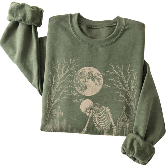 Folded Military Green sweatshirt with a skeleton petting a French Bulldog in a graveyard