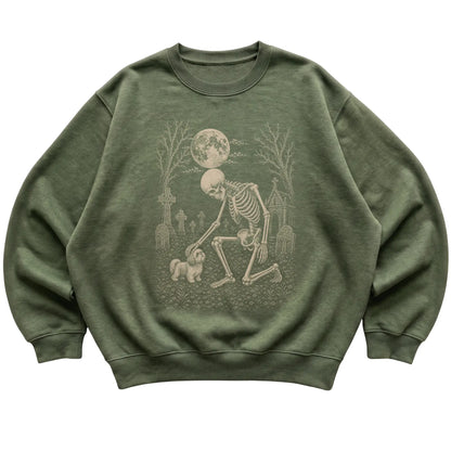 Skeleton petting a Shih Tzu in a graveyard on a Military Green sweatshirt