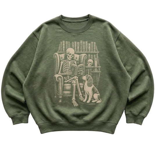 Skeleton reading Tales Beyond to a Springer Spaniel on a Military Green sweatshirt
