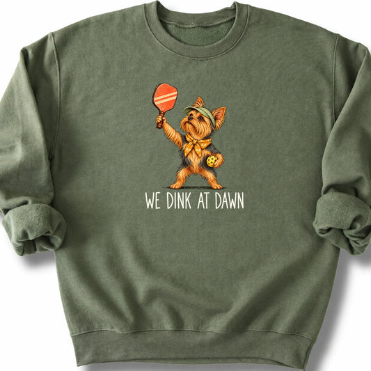 Yorkie with a pickleball paddle and ball on a Military Green Gildan® sweatshirt with We Dink at Dawn text
